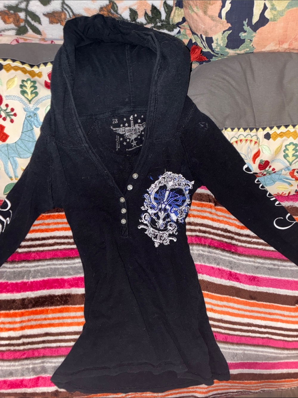 Black Hooded Women's Sweater with Blue Embellished Crest and words on sleeves